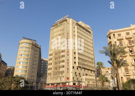 Cairo, Egypt, - February 4 2026: A street-level view in Cairo showing the Cleopatra Hotel amid tall office towers, palm trees, and a clear blue sky. Ideal for urban travel, business, and Egypt-focused imagery in Africa. Stock Photo