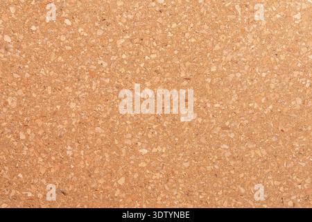 A detailed, full-frame backdrop made of pressed natural cork wood. Cork oak bark texture for an eco-friendly design. Stock Photo
