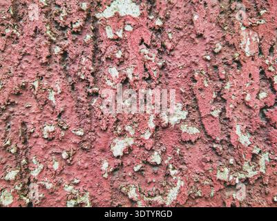 An abstract macro shot of a decaying pink wall at Ecseri út. The image captures the organic beauty of peeling paint and exposed plaster, ideal for gru Stock Photo