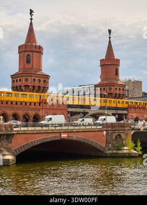 Berlin Oberbaum Bridge with Yellow U-Bahn Train over Spree River Stock Photo