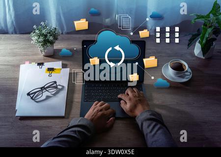 Cloud Storage Data Synchronization File Management on Laptop cloud storage and data synchronization icons representing business technology and remote Stock Photo