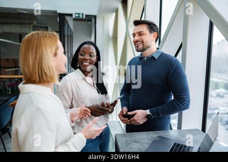 Diverse business people communicating and collaborating in a modern office Stock Photo