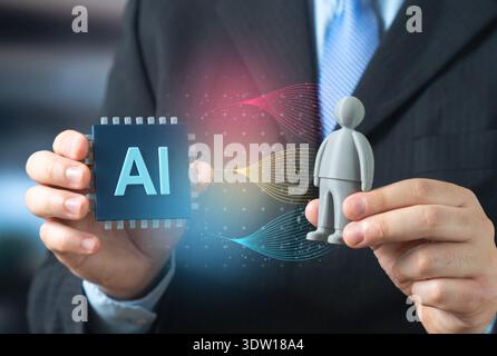 An AI microchip and a gray robot figurine. The creation of autonomous assistant robots powered by AI and neural networks. Smart automation and future Stock Photo