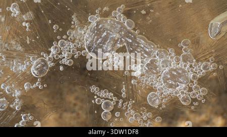 close-up shot of patterns in melting lake ice Stock Photo