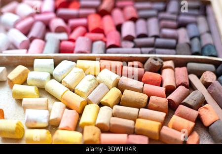 Yellow orange soft pastels set in wooden case. Art multicolor background. Chalk pieces top view. Artist supplies Stock Photo