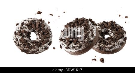 White chocolate glazed donuts with dark cookies crumbs and creme filled closeup flying. Sweet doughnuts isolated on white background banner Stock Photo