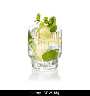 Refreshing cold drink with lemon slices and ice cubes, decorated with mint leaves, in striped glass isolated on white background. Alcoholic cocktail o Stock Photo