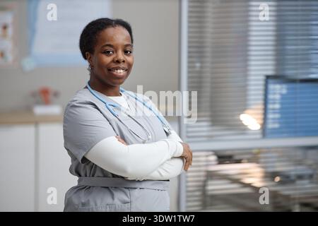 Portrait of Young Adult Black Woman Smiling Confidently in Medical Uniform Stock Photo