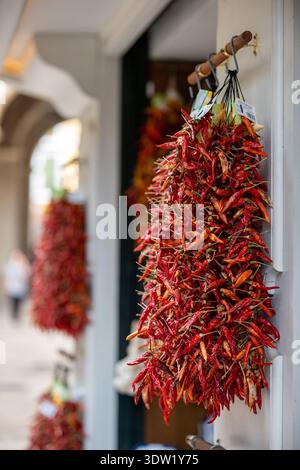 Close up view of hanging hot dried chili peppers on the local market in Palma de Mallorca, Spain Stock Photo
