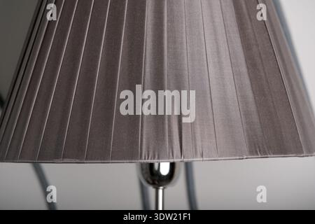 Soft fabric lamp shade brightens a calm space, creating a warm and inviting atmosphere. Stock Photo