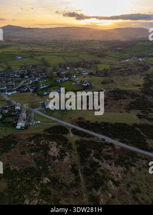 UK Weather: 24th February 2026. Warm temperatures nearing 15 degrees C in Flintshire and warming up further by Wednesday this week. The sun sets over a warm day over the Clwydian Range and  Moel Famau near the village of Rhes-y-Cae,, Flintshire, North Wales.  ©DGDImages/Alamy Live News Stock Photo