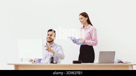 Team Members Discuss Project Progress in an Office Setting During Daytime Hours Stock Photo