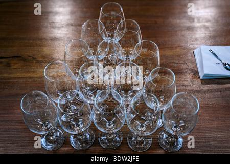 Otazu, Spain - June 23, 2021: Wine glasses lined up on a table for tasting in the underground barrel cellar at Bodega Otazu winery in Spain Stock Photo