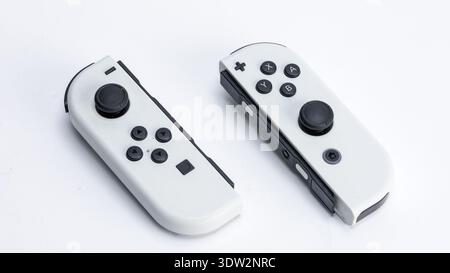 In this photo illustration, two Nintendo Switch Joy-Con controllers on a white background. Stock Photo