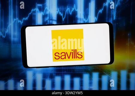 In this photo illustration, the Savills logo is seen displayed on a ...