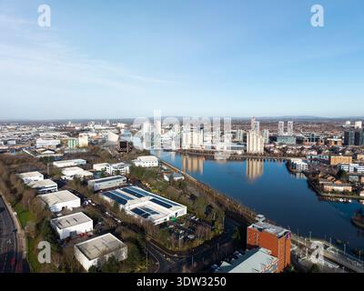 MANCHESTER, ENGLAND: FEBRUARY 17, 2026: Aerial view of industrial units alongside Manchester Ship Canal with Salford Quays waterfront development Stock Photo