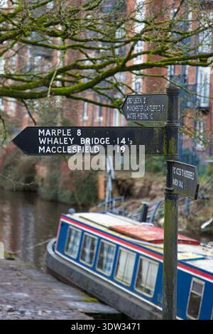 Traditional Canal Signpost and Narrowboat, Ashton Canal, Portland Basin, Tameside, UK. Stock Photo