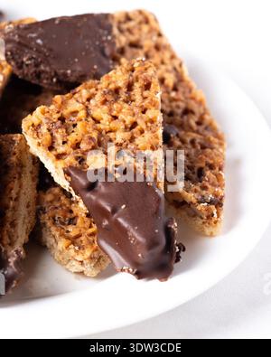 Details view walnut and coconut corners cookies dipped in white chocolate Stock Photo