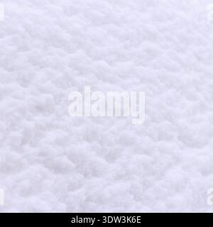 A close-up view of fresh, fluffy snow covering ground. Snow appears soft and untouched, creating a serene winter landscape Stock Photo