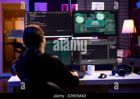 Hacker at home getting access denied error while doing computer sabotage using ransomware. Rogue programmer failing to penetrate firewalls while trying to steal victim data Stock Photo