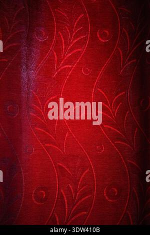 Intricate red fabric design with elegant patterns. Stock Photo