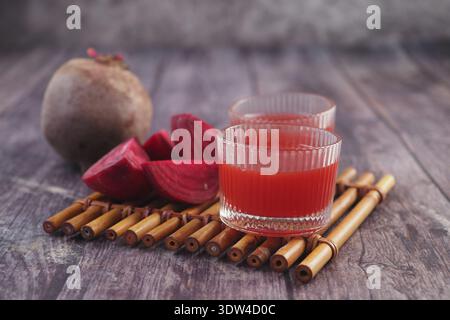 Fresh beet juice served on a wooden table with beets Stock Photo