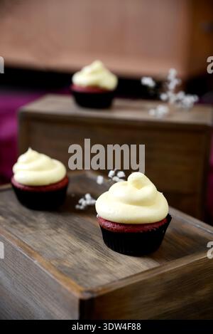 Aesthetic cookies and cream cupcakes on a rustic wooden background. Stock Photo