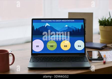 Laptop displaying deep meditation session interface on wooden desk, digital health and wellness application promoting mindfulness, calendar and pen visible in background, femtech context Stock Photo