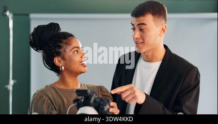 Smile, people and photographer with camera in studio for photoshoot results, catalog or selection. Woman, talking and backstage with model, review Stock Photo