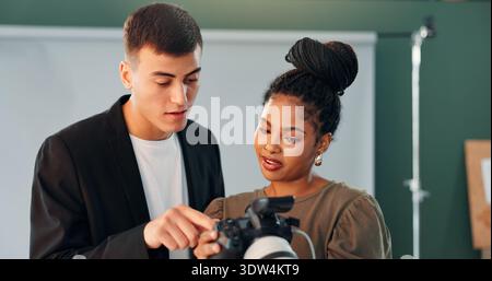 Conversation, photographer and model with camera in studio, review image and tips for expression check. Photography, tech or people with discussion Stock Photo