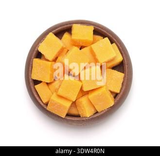 Top view of natural candied mango dice in wooden bowl isolated on white Stock Photo