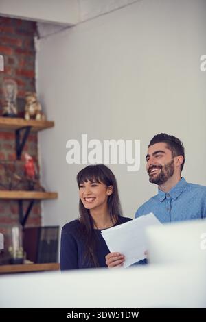 Man, woman and meeting with documents in home for floor plan, residential sale or property layout. Space, real estate agent and happy client with Stock Photo