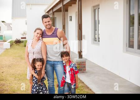 Portrait, parents and kids with smile in backyard for love, support and bonding together. Happy, family and embrace children for affection, connection Stock Photo