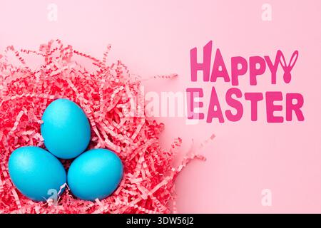 Colorful blue eggs in pink straw celebrate Easter holiday festivities and joy Stock Photo