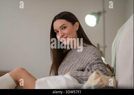 Smiling young woman looking happy and joyful Stock Photo