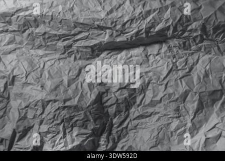 Crumpled gray paper texture background. Wrinkled abstract sheet surface minimal design. Industrial neutral backdrop concept. Stock Photo