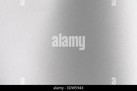 Gray gradient texture covers horizontal frame. Metallic surface displays light to dark transition. Abstract background for technology, branding, prese Stock Photo