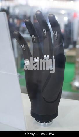 Bionic arm prosthesis. Plastic prosthesis printed on a 3D printer. Robotic arm. Robotics prosthesis for hand printed on a 3D printer from plastic powder. Modern new innovation medicine technologies. Stock Photo