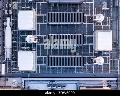 Rooftop of a modern data center with various hvac and cooling units covered in light snow, ensuring optimal server performance, Warszawa, Województwo Stock Photo