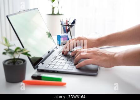 Man using laptop with blank screen, copy space Stock Photo