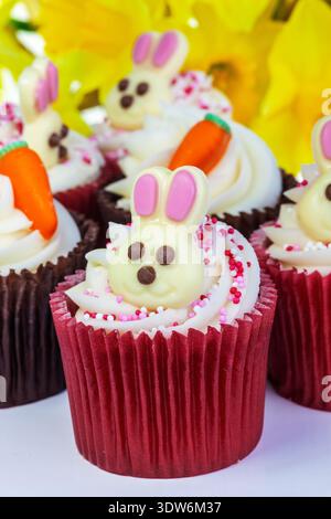 Cupcakes decorated with icing and shape of rabbit for Easter. Stock Photo