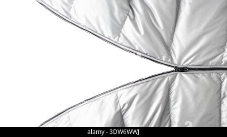 Open dark grey metal zipper on silver color winter down jacket isolated  on white background with copy space.  Detail of trendy silver metal color jac Stock Photo