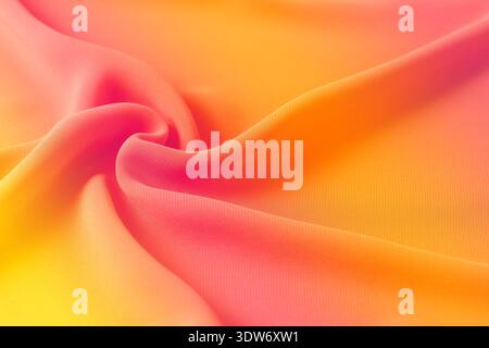 Abstract pink orange yellow gradient background. Blurred silk fabric draped texture Stock Photo
