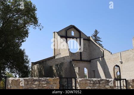 steel reinforced facade, brick, stone walls of preserved historic faith building, clear blue skies (landscape, sunshine, summer, ruins) Stock Photo