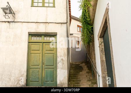 Close-up view of the entrance on an old  building in Porto, Portugal, narrow street with stone stairs Stock Photo
