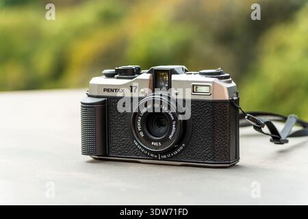 Porto, Portugal - August 28, 2024: the Pentax 17 is a half-frame 35mm film camera featuring manual controls, zone focusing, a fixed wide-angle lens, a Stock Photo
