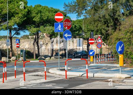 A mixture of many colourful roadsigns and barriers outside the entrance to the Greek Theatre in Syracuse, Sicily, Italy. Stock Photo