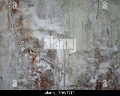 Cracked, worn and moldy wall surfaces as a grungy artistic background Stock Photo