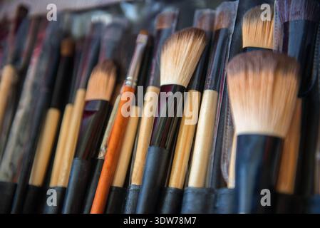 Set of professional makeup brushes neatly organized in a cosmetic case, showcasing beauty tools used for bridal preparation. Stock Photo