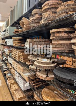 Pforzheim Germany Februar 25, 2026 Stacked Wooden Serving Boards And Trays On Metal Shelving, Round Chargers And Rectangular Cutting Blocks Stock Photo